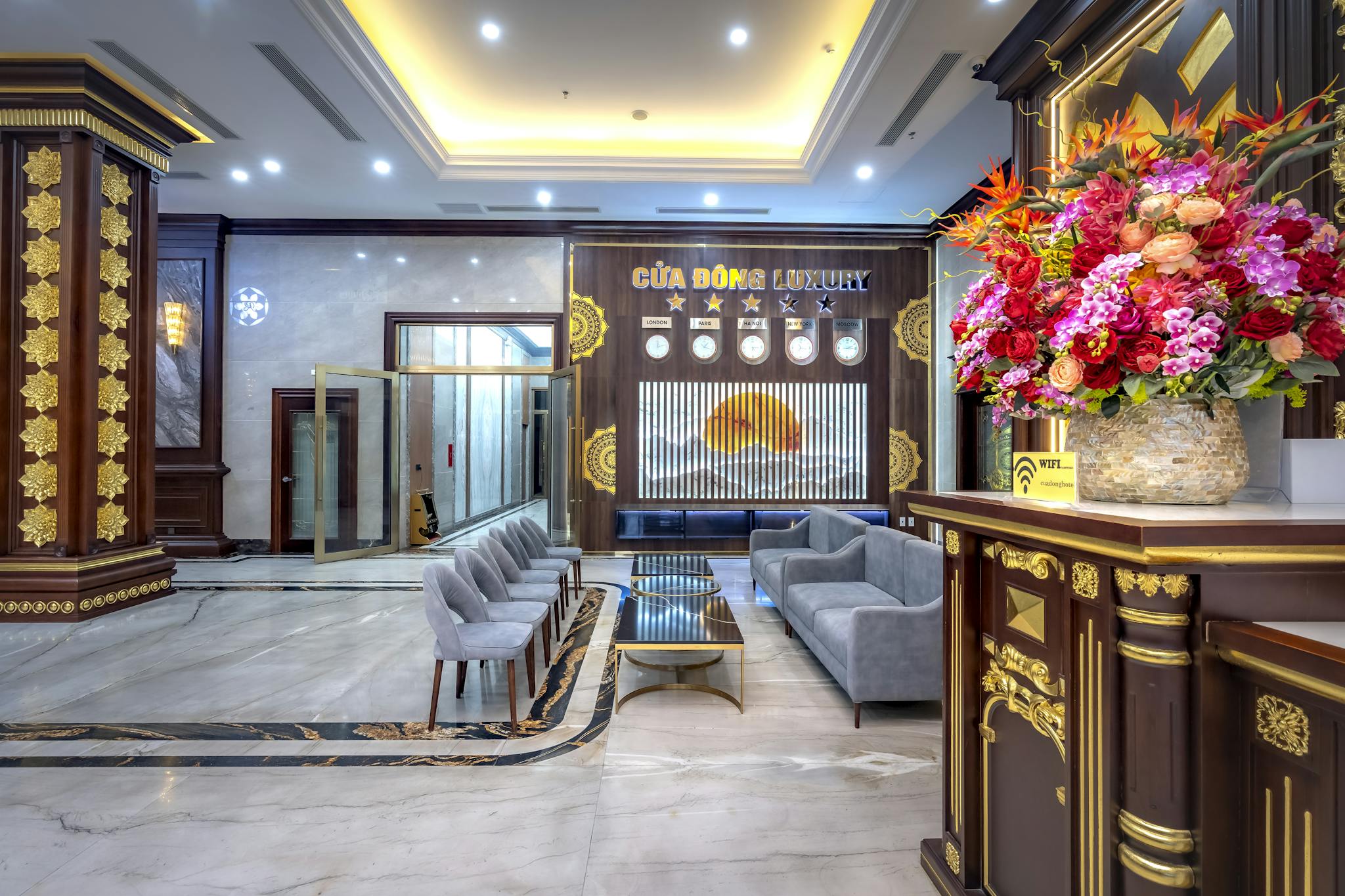 Lavish hotel lobby interior with floral decor and modern seating arrangement.